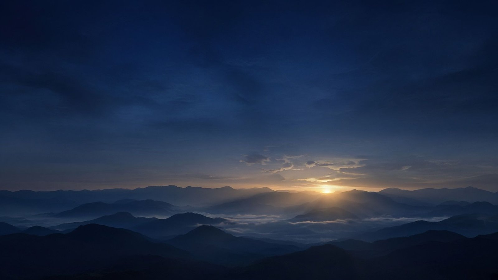 Misty blue mountains at sunrise